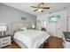 Main bedroom with king-size bed, ceiling fan, and TV at 7720 Rathdown Ln, Wesley Chapel, FL 33545