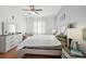 Main bedroom with king-size bed and dresser at 7720 Rathdown Ln, Wesley Chapel, FL 33545