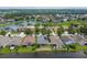 Aerial view of houses by a lake in a quiet residential area at 6843 Runner Oak Dr, Wesley Chapel, FL 33545
