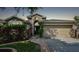 One-story house with a two-car garage and manicured landscaping at 6843 Runner Oak Dr, Wesley Chapel, FL 33545