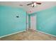 Teal bedroom with ceiling fan and closet at 6843 Runner Oak Dr, Wesley Chapel, FL 33545