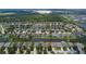 Aerial view of a residential community centered around a lake at 6843 Runner Oak Dr, Wesley Chapel, FL 33545