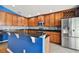 Modern kitchen featuring wood cabinets and granite island at 6843 Runner Oak Dr, Wesley Chapel, FL 33545