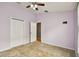 Bright bedroom featuring double doors and ceiling fan at 6843 Runner Oak Dr, Wesley Chapel, FL 33545