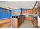 Open kitchen with breakfast bar, stainless steel appliances and blue walls at 6843 Runner Oak Dr, Wesley Chapel, FL 33545