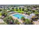 Aerial view of community pool with people swimming at 6843 Runner Oak Dr, Wesley Chapel, FL 33545