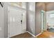 Inviting entryway with a white door and gray walls at 6843 Runner Oak Dr, Wesley Chapel, FL 33545