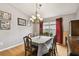 Spacious dining area with hardwood floors and red curtains at 6843 Runner Oak Dr, Wesley Chapel, FL 33545