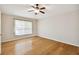 Spacious bedroom with hardwood floors and a ceiling fan at 6843 Runner Oak Dr, Wesley Chapel, FL 33545