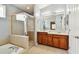 Bathroom with double vanity, shower, and soaking tub at 6843 Runner Oak Dr, Wesley Chapel, FL 33545