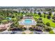 Aerial view of community pool, playground, and homes at 6843 Runner Oak Dr, Wesley Chapel, FL 33545
