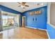 Living room with blue walls and sliding glass doors at 6843 Runner Oak Dr, Wesley Chapel, FL 33545