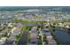 Aerial view of a residential area featuring houses and waterways at 6843 Runner Oak Dr, Wesley Chapel, FL 33545