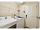 Laundry room with washer, dryer, and shelving at 6843 Runner Oak Dr, Wesley Chapel, FL 33545