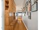 Long hallway with built-in wooden storage and Gathering photos at 6843 Runner Oak Dr, Wesley Chapel, FL 33545