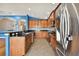 Modern kitchen with stainless steel appliances and wood cabinets at 6843 Runner Oak Dr, Wesley Chapel, FL 33545