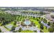 Aerial view of community with pool, park, and homes at 6843 Runner Oak Dr, Wesley Chapel, FL 33545