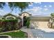 House exterior with a welcoming front porch and landscaping at 6843 Runner Oak Dr, Wesley Chapel, FL 33545