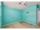 Teal bedroom with ceiling fan and closet at 6843 Runner Oak Dr, Wesley Chapel, FL 33545