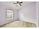 Lavender bedroom with a window and ceiling fan at 6843 Runner Oak Dr, Wesley Chapel, FL 33545
