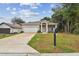 Home with a white garage door and a spacious driveway at 6439 Taylor Ct, New Port Richey, FL 34653