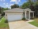 One-story house with a white garage door and landscaping at 6439 Taylor Ct, New Port Richey, FL 34653