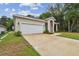 Tan house with a white garage door and driveway at 6439 Taylor Ct, New Port Richey, FL 34653
