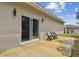 Small patio with seating area, adjacent to sliding glass door at 6439 Taylor Ct, New Port Richey, FL 34653