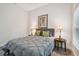 Well-lit bedroom featuring gray bedding and wood floors at 6439 Taylor Ct, New Port Richey, FL 34653