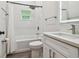 Modern bathroom with white vanity, tub, and shower at 6439 Taylor Ct, New Port Richey, FL 34653