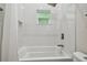 Bathroom with shower/tub combo and white tile at 6439 Taylor Ct, New Port Richey, FL 34653