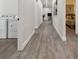 Long hallway with wood-look floors, leading to laundry and bedrooms at 6439 Taylor Ct, New Port Richey, FL 34653