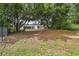 Large backyard with mature trees and a chain link fence at 6439 Taylor Ct, New Port Richey, FL 34653