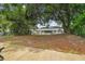 Large backyard with mature trees and patio at 6439 Taylor Ct, New Port Richey, FL 34653