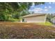 Large backyard with mature trees and a chain link fence at 6439 Taylor Ct, New Port Richey, FL 34653