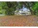 Large backyard with mature trees and a chain link fence at 6439 Taylor Ct, New Port Richey, FL 34653