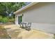 Small patio with seating area, adjacent to sliding glass door at 6439 Taylor Ct, New Port Richey, FL 34653
