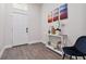 Bright entryway with white door, wood-look floors, and decorative console table at 6439 Taylor Ct, New Port Richey, FL 34653