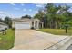 Newly built home with a white garage door and a small yard at 6439 Taylor Ct, New Port Richey, FL 34653