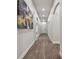 Bright hallway with wood-look floors and modern wall art at 6439 Taylor Ct, New Port Richey, FL 34653
