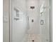 Large walk-in shower with a frameless glass enclosure and pebble floor at 6439 Taylor Ct, New Port Richey, FL 34653