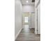 Hallway with wood-look floors and access to bedrooms at 6439 Taylor Ct, New Port Richey, FL 34653