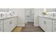Double vanity bathroom with white cabinets and a gray floor at 6439 Taylor Ct, New Port Richey, FL 34653