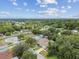 Aerial view of a neighborhood featuring houses, a pool, and tree-lined streets at 6439 Taylor Ct, New Port Richey, FL 34653