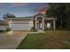 One-story house with a white garage door and landscaping at 6439 Taylor Ct, New Port Richey, FL 34653