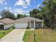 Newly built home with a single-car garage and welcoming front porch at 6439 Taylor Ct, New Port Richey, FL 34653