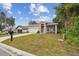 House with a white garage door, mailbox, and a small yard at 6439 Taylor Ct, New Port Richey, FL 34653