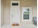 Front door with a welcome mat and keyless entry at 6439 Taylor Ct, New Port Richey, FL 34653