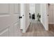 Light and bright hallway with wood-look floors leading to bedrooms at 6439 Taylor Ct, New Port Richey, FL 34653