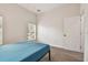 Bedroom with blue bed, wood-look floors, and window at 6439 Taylor Ct, New Port Richey, FL 34653
